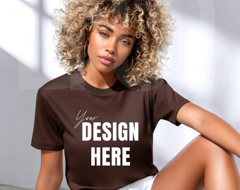 May include: A brown t-shirt with the text "Your DESIGN HERE" in white. The t-shirt is short-sleeved and has a crew neck. The model is wearing white shorts.
