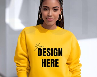 May include: A bright yellow sweatshirt with the text "Your DESIGN HERE" in black. The sweatshirt is a crew neck style. The model is wearing a patterned headband and gold hoop earrings.