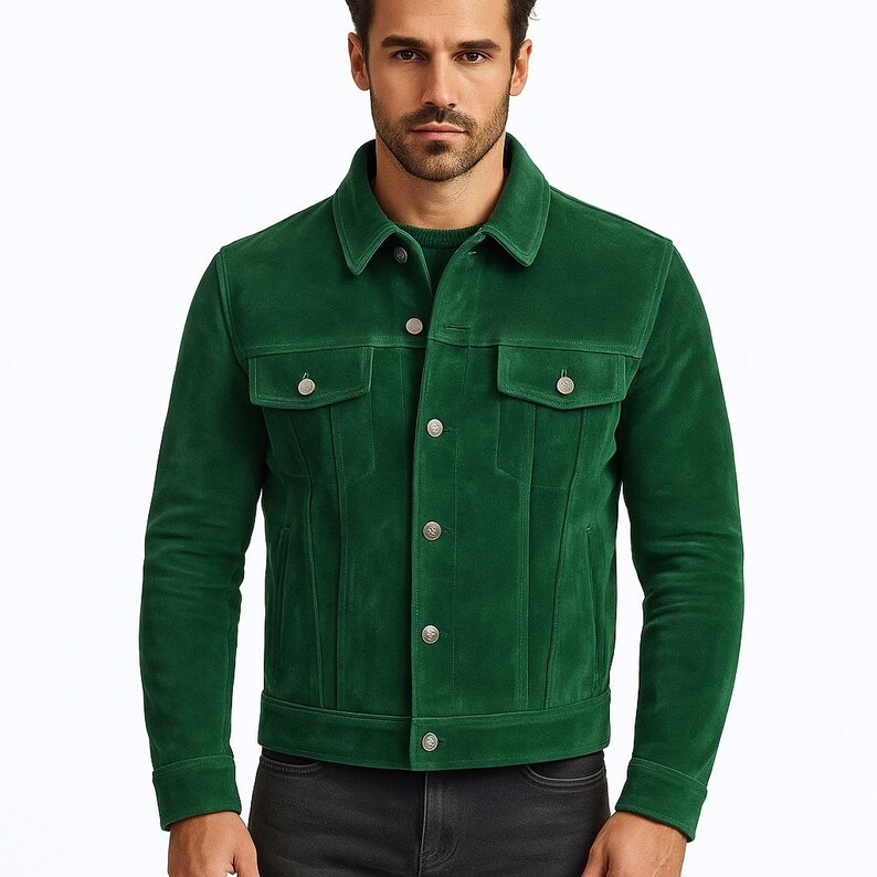 May include: A striking green suede jacket with a traditional collar and button closure. It has two chest pockets and silver buttons. This jacket is a fashionable outerwear item.