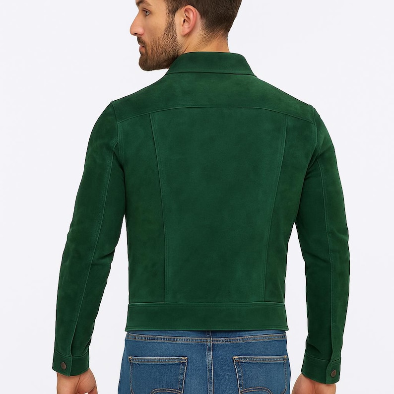 May include: A dark green suede jacket with a classic collar and buttoned cuffs. The jacket has a tailored fit and is worn with blue jeans. The back view of the jacket shows the seams and design details.