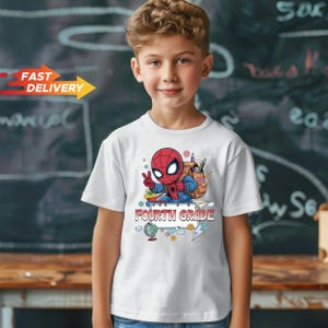 May include: A white short-sleeved t-shirt featuring a graphic of a cartoon Spider-Man character wearing a backpack, making a peace sign, and standing above the text "FOURTH GRADE" with illustrations of a globe, pencil, and lightning bolt.