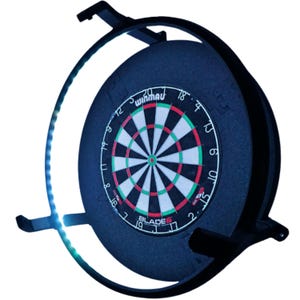 May include: A black dartboard with a red, white, and green target design. The dartboard is mounted on a black frame with a built-in LED light ring. The brand name "Winmau" is visible on the board.