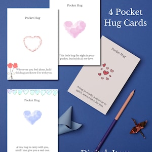 May include: Four "Pocket Hug" cards with heart illustrations and comforting messages. The cards are white with pink, red, and blue heart designs. Text includes "Whenever you feel alone, hold this hug and know I'm with you."