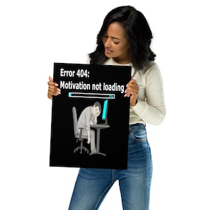 May include: A black poster with the text "Error 404: Motivation not loading" and an illustration of a person slumped over a computer. The loading bar shows 5%. The poster is held by a person.