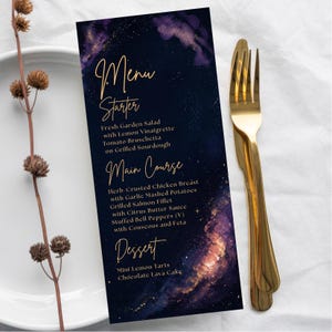 May include: A dark blue menu card with gold lettering and a celestial design. The menu lists starters, main courses, and desserts, including Fresh Garden Salad, Herb Crusted Chicken Breast, and Mini Lemon Tarts. A gold fork and knife are on the right.