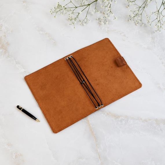 A genuinely handmade refillable leather journal cover with monogram — the 196 favorites signal real demand for a craft item that takes real skill to produce.