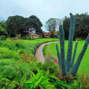 May include: A scenic outdoor shot of a garden path winding through lush greenery. The path leads towards a quaint building. Tall, slender tree trunks wrapped in teal fabric stand in the foreground, adding a unique element to the landscape.