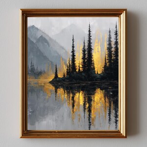 May include: A framed landscape painting depicts a serene lake scene with silhouetted evergreen trees and mountains. The artwork features a gold and black color palette, with the trees reflecting in the water. The frame is a warm gold color.