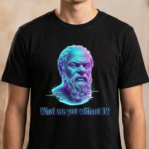 May include: Black t-shirt featuring a neon blue and purple graphic of a bust with the text "What are you without it?" The graphic has a glitch effect. The t-shirt is worn by a person.