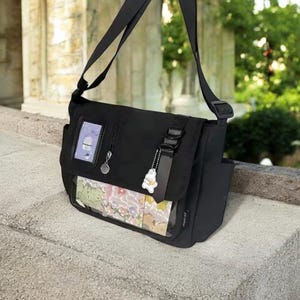 Ita bag messenger style with clear display pocket for pins keychains and badges perfect for school or everyday use