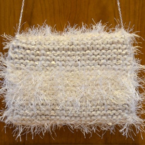 Creamy Frill very soft knitted iridescent ivory ribbon yarn with ivory eyelash yarn throughout. image 2