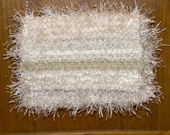 Creamy Frill - very soft knitted iridescent ivory ribbon yarn with ivory eyelash yarn throughout.