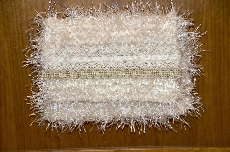 Creamy Frill very soft knitted iridescent ivory ribbon yarn with ivory eyelash yarn throughout. image 1