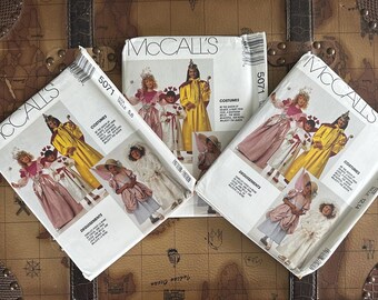 May include: Three McCall's costume pattern envelopes, featuring illustrations of children in various costumes. The patterns include designs for princess, fairy, and royal attire. The envelopes are white with the number 5071 printed on them.