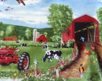 May include: A red tractor with a red barn and a red covered bridge in the background. There are cows and birds in the field. The scene is a rural farm setting.