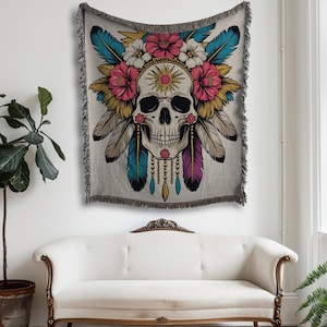 woven throw blanket featuring a detailed skull adorned with vibrant flowers, mystical feathers, and a radiant sun symbol