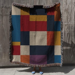 modern woven throw blanket featuring a striking geometric color block design