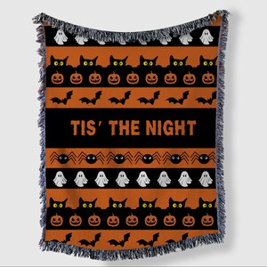 May include: Halloween throw blanket with orange and black stripes. Features repeating patterns of black cats, jack-o'-lanterns, bats, spiders, and ghosts. The phrase "TIS' THE NIGHT" is displayed in bold white letters.