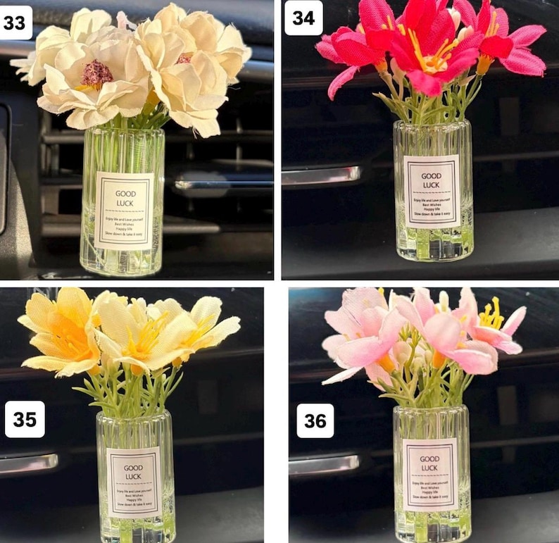 May include: A collection of small glass vases, each filled with artificial flowers. The flowers vary in color, including cream, red, yellow, and pink. Each vase has a label that reads "GOOD LUCK".
