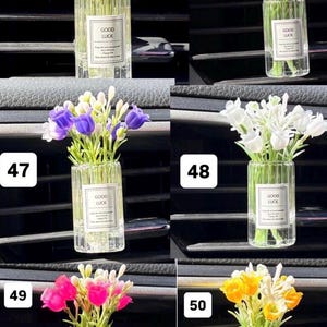 May include: A collection of small glass vases, each filled with colorful artificial flowers. Each vase has a label that reads "GOOD LUCK". The flowers are in various colors, including red, pink, purple, white, and yellow.