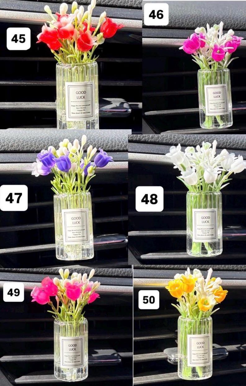 May include: A collection of small glass vases, each filled with colorful artificial flowers. Each vase has a label that reads "GOOD LUCK". The flowers are in various colors, including red, pink, purple, white, and yellow.