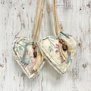 May include: A set of three ceramic mugs with a speckled, matte finish. The mugs are in shades of cream, light gray, and dark gray. Each mug has a simple, minimalist design, perfect for coffee or tea.