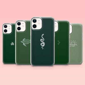 May include: Five green phone cases, each with a different white line drawing: a turtle, a snake, a small turtle, two hearts, and a sun over waves. The cases are in different shades of green and designed to fit a smartphone.