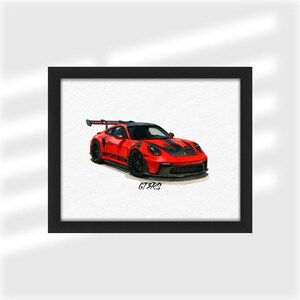 Może przedstawiać: Oprawiona grafika przedstawiająca czerwony samoch&oacute;d sportowy z czarnymi detalami i tylnym spojlerem. Samoch&oacute;d ma napis "GT3RS" z boku. Grafika jest w czarnej ramie.