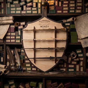 May include: A wooden wand display with the text "Ollivander's Makers of Fine Wands" and several wands. The display is on a shelf filled with boxes and scrolls. A lamp hangs above the display.