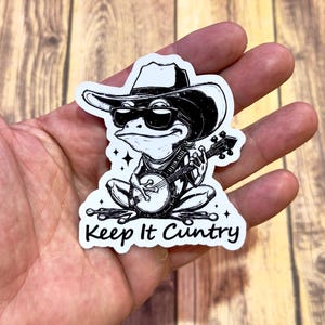 Keep It Cuntry-sticker, grappige kikkerlandsticker, sarcastische landsticker, grappige westernsticker, kikkersticker, kikker die banjo speelt,