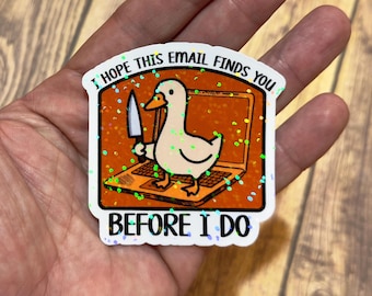 May include: A sticker featuring a cartoon duck holding a knife, standing on a laptop. The sticker has the text "I HOPE THIS EMAIL FINDS YOU BEFORE I DO" in white letters. The background is orange with glitter.