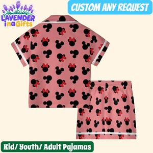 A pink pajama set with a repeating pattern of black Minnie Mouse ears and red bows.