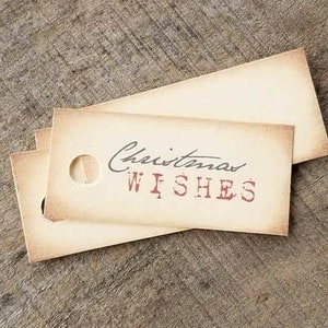 May include: Two brown paper gift tags with a hole punched in the top. The top tag has the text "Christmas Wishes" printed in red.