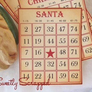 May include: A bingo card with the word "SANTA" at the top and numbers 1-75 in a 5x5 grid. The center square has a red star instead of a number. The card is printed on a tan background with red borders.