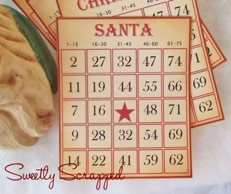 May include: A bingo card with the word "SANTA" at the top and numbers 1-75 in a 5x5 grid. The center square has a red star instead of a number. The card is printed on a tan background with red borders.