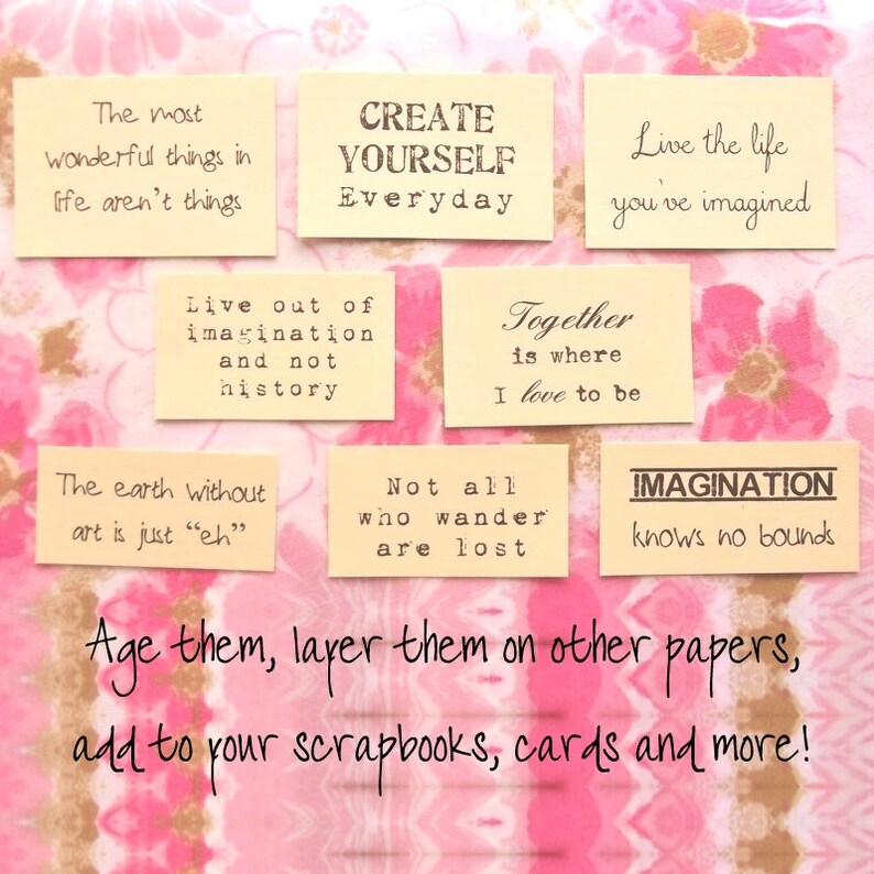 May include: A collection of cream-colored rectangular paper tags with inspirational quotes in black text. The tags are arranged on a pink floral patterned background. The text includes phrases like "Create Yourself Everyday" and "Imagination knows no bounds."