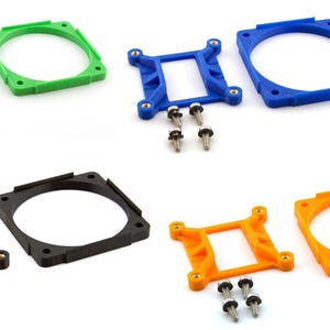 May include: A collection of computer fan mounting brackets in various colors: green, blue, black, and orange. Each bracket is shown with its corresponding screws. The brackets are square or circular with mounting holes.
