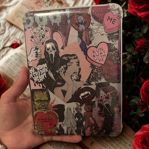 May include: A clear phone case featuring a collage of vintage illustrations. The design includes a screaming face, a woman on the phone, hearts, and various spooky characters. The case has a glittery finish and a pink and black colour scheme.