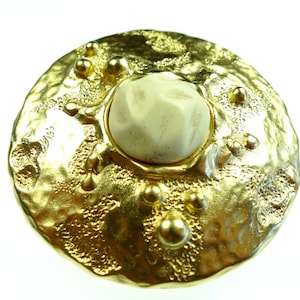 Belt buckles,  matte gold tone metal with a white cabochon