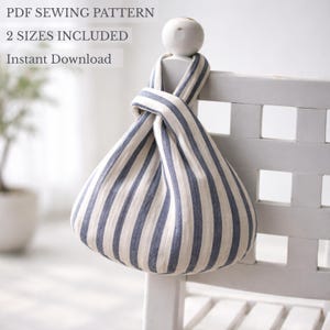 May include: A fabric bag with a blue and white vertical striped pattern, featuring a knotted handle design. The text PDF SEWING PATTERN, 2 SIZES INCLUDED, and Instant Download is visible in the upper left corner of the image.