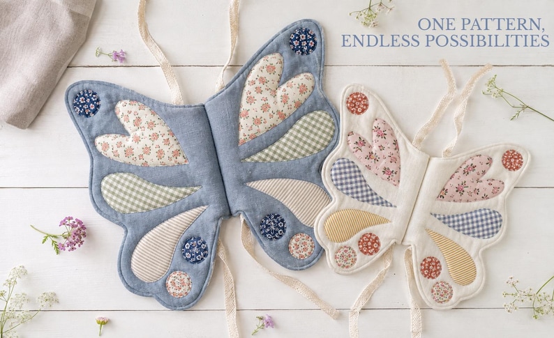 May include: Two fabric butterfly wing costumes with tie straps. The left wing is blue with floral, gingham, and striped patches. The right wing is cream with similar patterned patches. Text reads: ONE PATTERN, ENDLESS POSSIBILITIES.