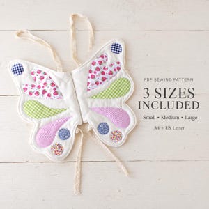 May include: A fabric butterfly costume with white base and colorful patches including strawberry prints, green and purple gingham, and floral circles. Text reads: PDF SEWING PATTERN 3 SIZES INCLUDED Small Medium Large A4 + US Letter.