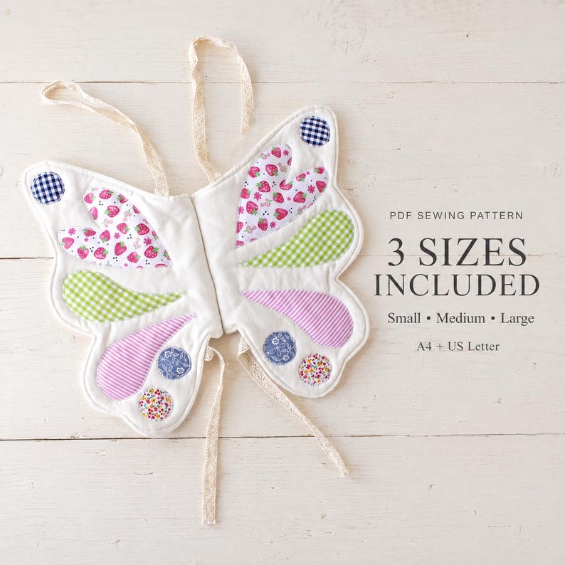 May include: A fabric butterfly costume with white base and colorful patches including strawberry prints, green and purple gingham, and floral circles. Text reads: PDF SEWING PATTERN 3 SIZES INCLUDED Small Medium Large A4 + US Letter.