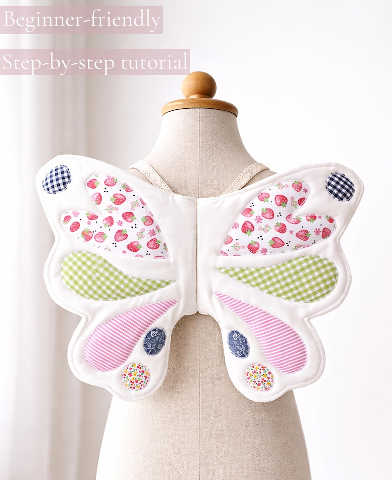 May include: Fabric butterfly wings featuring white base fabric with quilted sections of strawberry, green gingham, pink striped, and floral patterns. The wings include small circular accents in navy gingham and floral prints, with the text "Beginner-friendly" and "Step-by-step tutorial" visible at the top.