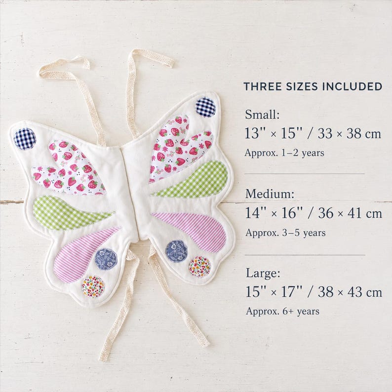 May include: Quilted butterfly wings with strawberry, gingham, and floral patterns. Text reads: THREE SIZES INCLUDED. Small: 13" x 15" (1-2 years). Medium: 14" x 16" (3-5 years). Large: 15" x 17" (6+ years). Includes cream-colored fabric ties.