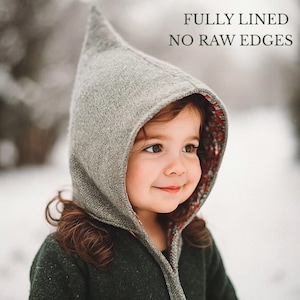 May include: A grey pointed hood with a textured exterior and a floral patterned lining. The hood features a seam running down the center and is fully lined with no raw edges, as indicated by the text overlay: FULLY LINED NO RAW EDGES.