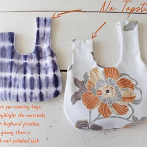 May include: Two fabric bags with a Japanese knot handle design. The left bag features a dark blue and white tie-dye pattern. The right bag has a white base with a large orange and grey floral print. Text on the image reads No Topstitch!