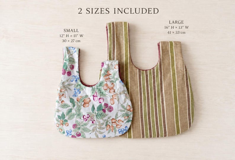 May include: Two fabric bags with 2 SIZES INCLUDED text. The small bag measures 12 inches H by 11 inches W and features a white background with a colorful berry and nut pattern. The large bag measures 16 inches H by 13 inches W with brown and green stripes.