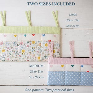 May include: Two fabric hanging organizers with three pockets each. The large organizer features green stripes and a floral print, measuring 26in x 13in. The medium organizer has pink stripes and blue polka dots, measuring 23in x 11in. Both include heart icons.