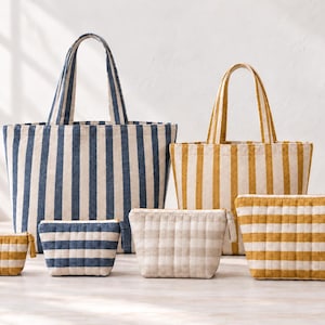 May include: Two large tote bags and four smaller zippered pouches. One tote and one pouch feature vertical blue and white stripes. The other tote and three pouches feature vertical or horizontal yellow and white stripes with a quilted texture.